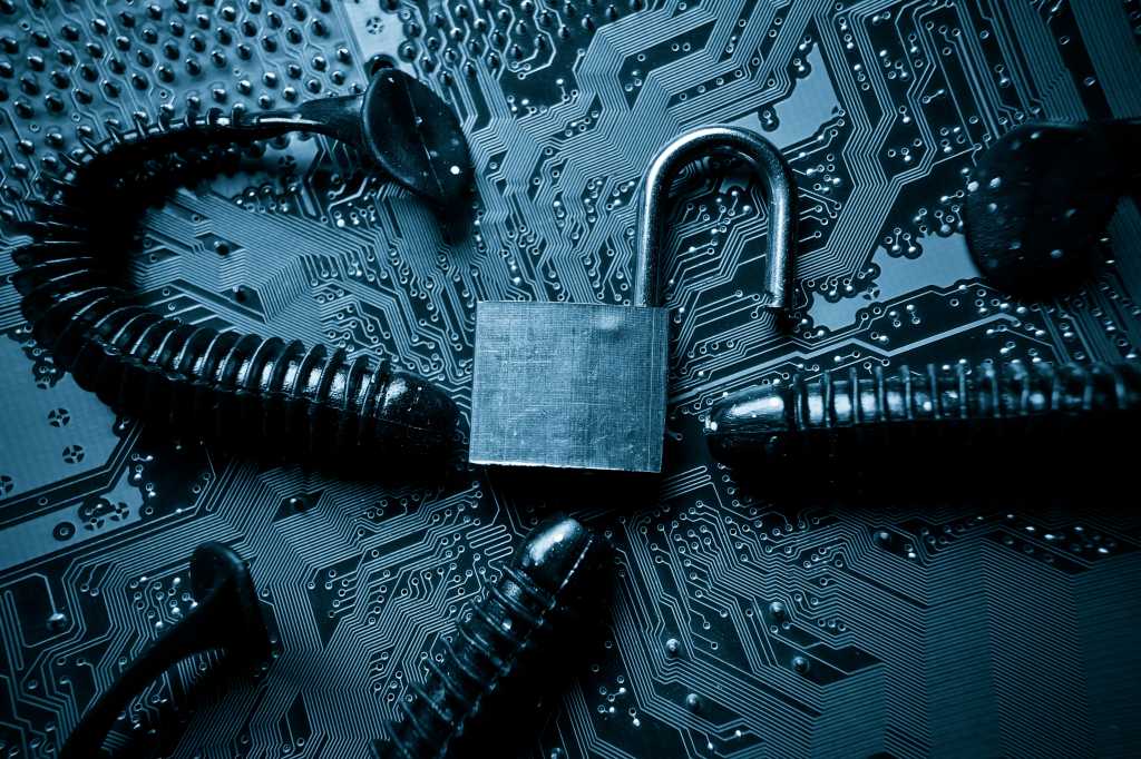 computer security breach due to worm attack - worm on computer circuit board with open security lock